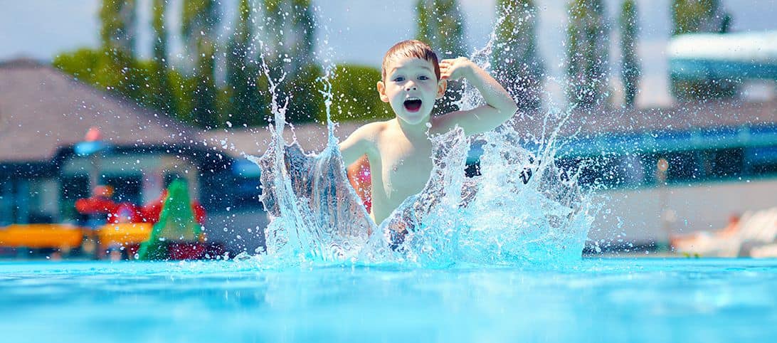 Child plashing water around in a pool