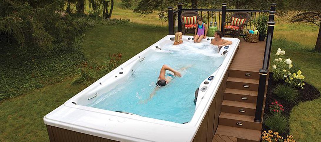 Family sitting in backyard swim spa